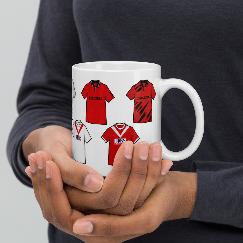 High-quality mug inspired by the famous historical classic football jerseys of Airdrieonians FC. This design pays tribute to iconic kits worn throughout the club’s proud history, celebrating one of Scotland’s most storied football clubs.
Inspired by classic Airdrieonians football kits, colours, and heritage — this is a unique fan-made piece created to honour the legacy of The Diamonds.
This product is unofficial and fan made and is not affiliated with any club or brand