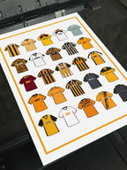 Hull City Retro Shirts Art Print featuring 25 hand-drawn classic football shirts, showcasing the club’s most iconic kits through the years. A celebration of the Tigers’ rich history and evolving style, captured in detailed, vintage-inspired illustrations