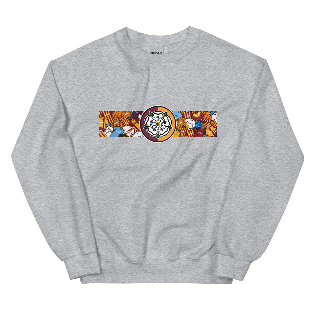 Bradford City FC-inspired retro football sweatshirt featuring a bold central Yorkshire rose design. This unisex pullover combines vintage kit aesthetics with warm, everyday comfort—perfect for chilly match days, pub nights, or casual wear. The design pays tribute to classic Bantams jerseys and proudly reflects Bradford’s rich football heritage and Yorkshire identity. A great gift or wardrobe staple for loyal fans who love retro football culture and their hometown pride