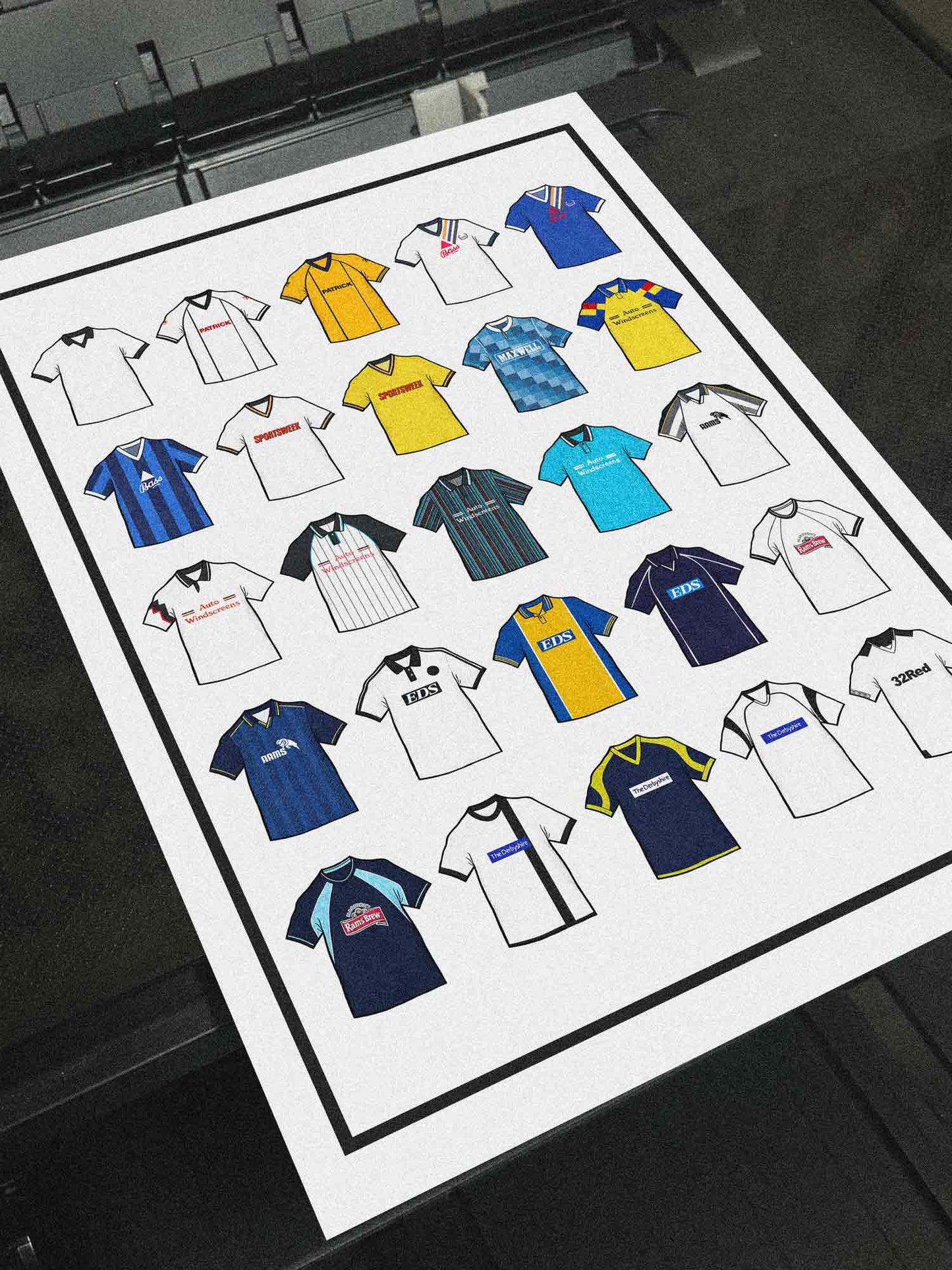 Poster artwork inspired by Derby County FC shirts, featuring a stylized design with bold black and white elements. The piece showcases 25 hand-drawn retro shirts, incorporating vintage jersey patterns and textures that reflect the proud tradition and rich heritage of Derby County Football Club. It blends classic elements with a sharp, contemporary aesthetic, celebrating the enduring spirit of the Rams and the club’s historic legacy at Pride Park and the Baseball Ground.