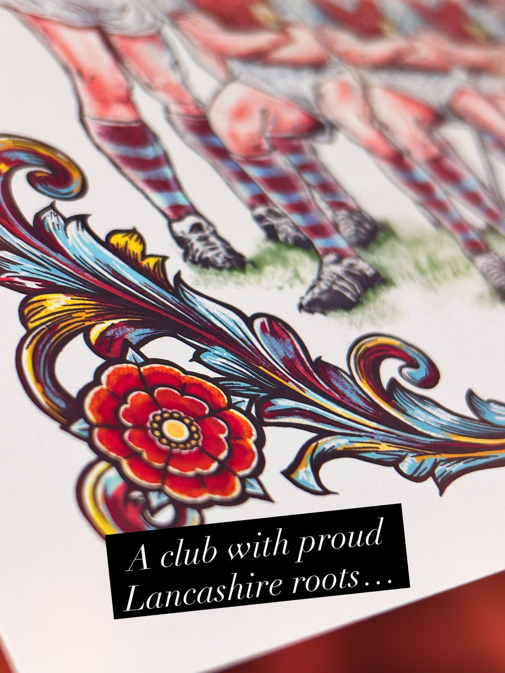 Colorful design inspired by Burnley Football Club with floral elements and text about Lancashire roots on a white background